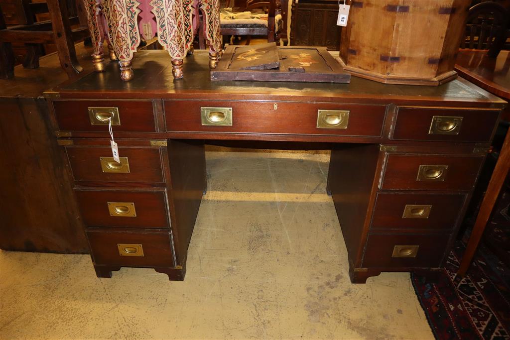 A reproduction mahogany military style pedestal desk, width 138cm, depth 69cm, height 76cm